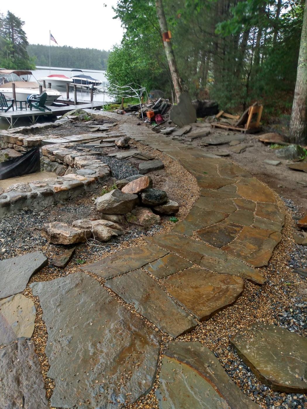 Flagstone walkway curving toward the lake
